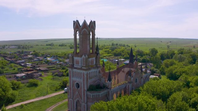 Church of St. Mary in the neo-gothic style in the village of Kamenka, Saratov region, Russia. The ruins of the church wall. Aero 4K