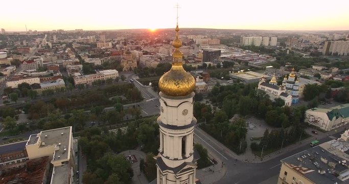 Aerial view to Holy Dormition Cathedral (Uspenskiy sobor) at sunset with panorama of Kharkiv city, Ukraine