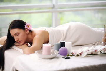 Spa concert. beautiful young girl lying on a massage table in a spa salon. Beauty, spa, healthy lifestyle