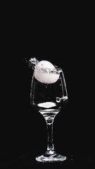 fresh water splashing, while a lemon falling in to a wine glass.