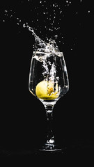 fresh water splashing, while a lemon falling in to a wine glass.
