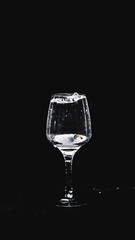 fresh water splashing, while a lemon falling in to a wine glass.