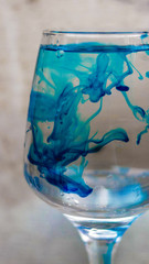 blue colour dissolving in water.