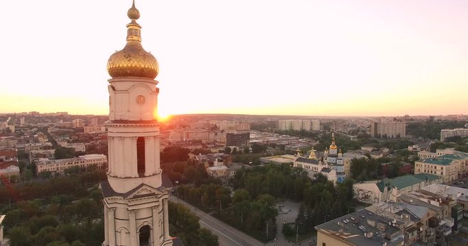 Aerial view to Holy Dormition Cathedral (Uspenskiy sobor) at sunset with panorama of Kharkiv city, Ukraine