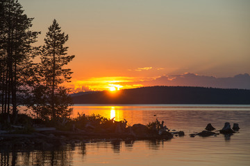 White nights over the calm nordic forest lake