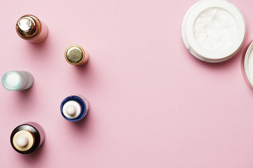 women's cosmetics on a pink background. flat lay
