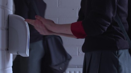 School student washing sanitising hands to stop spread of coronavirus - Powered by Adobe