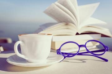 Coffee cup and books outdoors