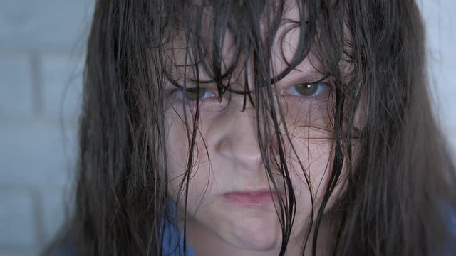 Angry grumpy face. Portrait of an angry little girl with facial hair.