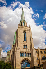 Fototapeta na wymiar Cityscape of Tulsa Oklahoma USA with gothic chruch with copper spires in foreground