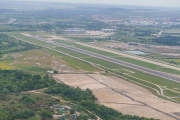 Aerial view of one of the runways at Adolfo Suarez airport and surroundings on a cloudy day.