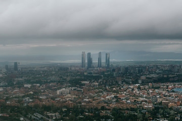 Fototapeta na wymiar Madrid aerial view in a very cloudy day with a sky scrapers in the background. Landscape. Famous places.
