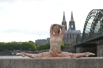 A beautiful ballet dancer ballerina outdoors ,Ballerina dancing on the bridge  in Cologne City .