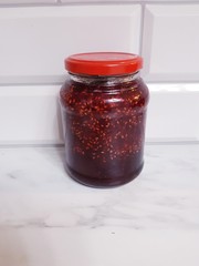 delicious raspberry jam on white background