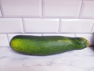 Dark green zucchini on white background