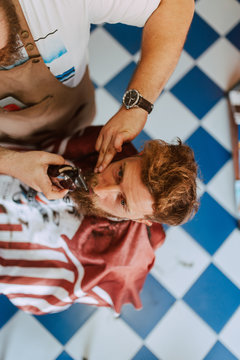 Close up of hands of a hairdresser cutting a young caucasian man's hair. Making a new hairstyle