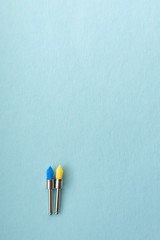 dental burs for polishing fillings on a blue background. blue and yellow woods on the background. vertical photo. Tools for the work dentist close up background