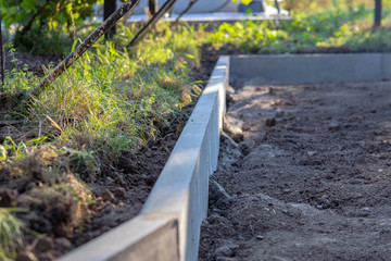 Installation of curbs. laying curb stones using concrete. Selective focus.