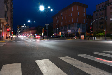 Timelapse view of traffic at an urban night intersection. Urban movement in the Italian city in the evening.