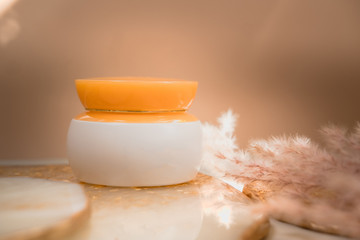 White cosmetic cream jar mockup on golden glow background