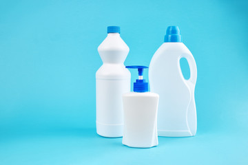 group of blank detergent product bottles over blue background. copy space. cleaning and washing equipment concept