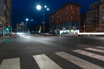 Timelapse view of traffic at an urban night intersection. Urban movement in the Italian city in the evening.