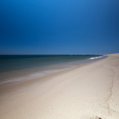 Fototapeta na wymiar Small waves break along the remote eastern beaches of Provincetown