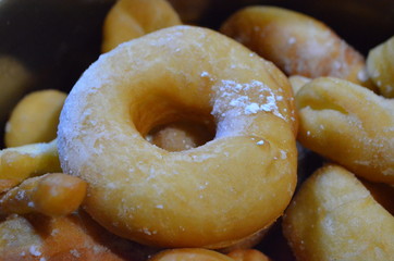 Homemade doughnuts sprinkled with powdered sugar