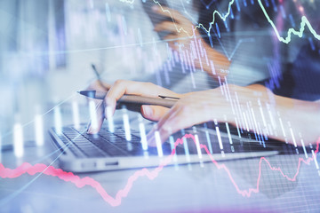 Multi exposure of woman hands typing on computer and financial graph hologram drawing. Stock market analysis concept.