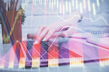 Multi exposure of woman hands typing on computer and forex chart hologram drawing. Stock market analysis concept.