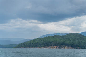 Fototapeta premium Russia, Irkutsk region, Baikal lake, July 2020: boat leaving splashes and traces on baikal water