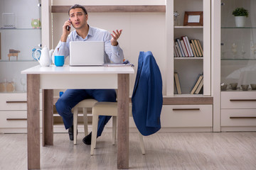 Young male employee working from the house