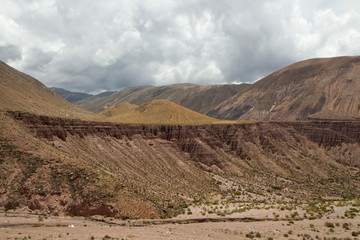 Desert landscape. View of the mountains, sandstone cliffs and valley under a beautiful cloudy sky.  