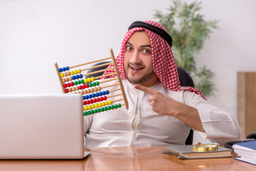Young male arab employee working in the office