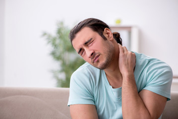 Young man suffering from sore throat