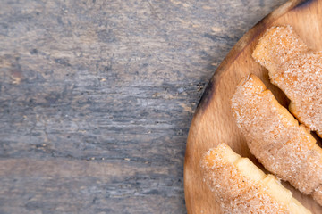 Fresh croissants with cinnamon on wooden background table. Top view
