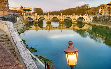 Street lamp. St. Angelo Bridge, Tiber River reflection, Rome, Italy. Bridge first built by Emperor...