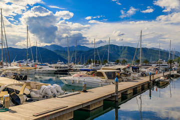 Scenic view of the Adriatic Sea marina with boats and mountains in the background in Tivat Montenegro