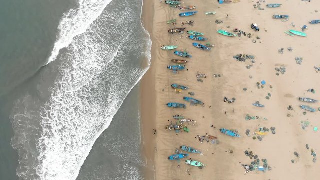 4k Drone footage of busy fishing village with incoming boats in Tamil Nadu, India