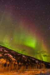 USA, Alaska, Fairbanks. Aurora borealis over mountain landscape. Credit as: Cathy & Gordon Illg /...