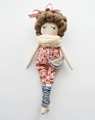 Heirloom textile doll with curly hair wearing cute floral overalls, felt gray handbag, striped gaiters and vanilla guipure scarf	