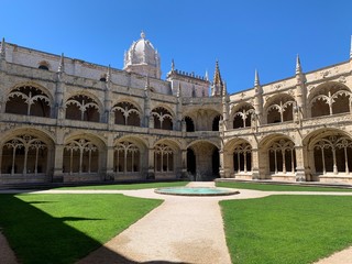 Fototapeta premium Inside the beautiful Hieronymites Monastery of Jeronimos with the beautiful green garden in Belem, Lisbon, Portugal