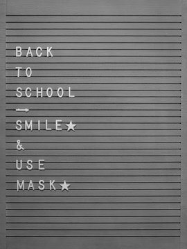 back to school  board with smile & use mask message