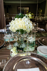 Elegant outdoors summer wedding with flowers decoration and mirrors