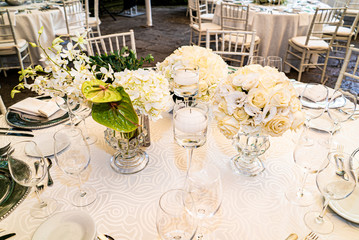 Elegant outdoors summer wedding with flowers decoration and mirrors
