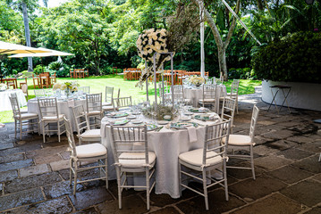 Elegant outdoors summer wedding with flowers decoration and mirrors