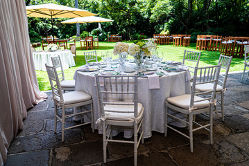 Elegant outdoors summer wedding with flowers decoration and mirrors