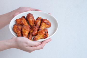 Hand holding new orleans chicken wings.
