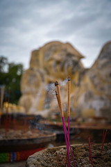 Incense sticks and a reclining buddha