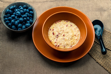 Oatmeal with different berries. healthy breakfast steel cut oatmeal porridge with blueberry blackberry. Porridge and blueberries